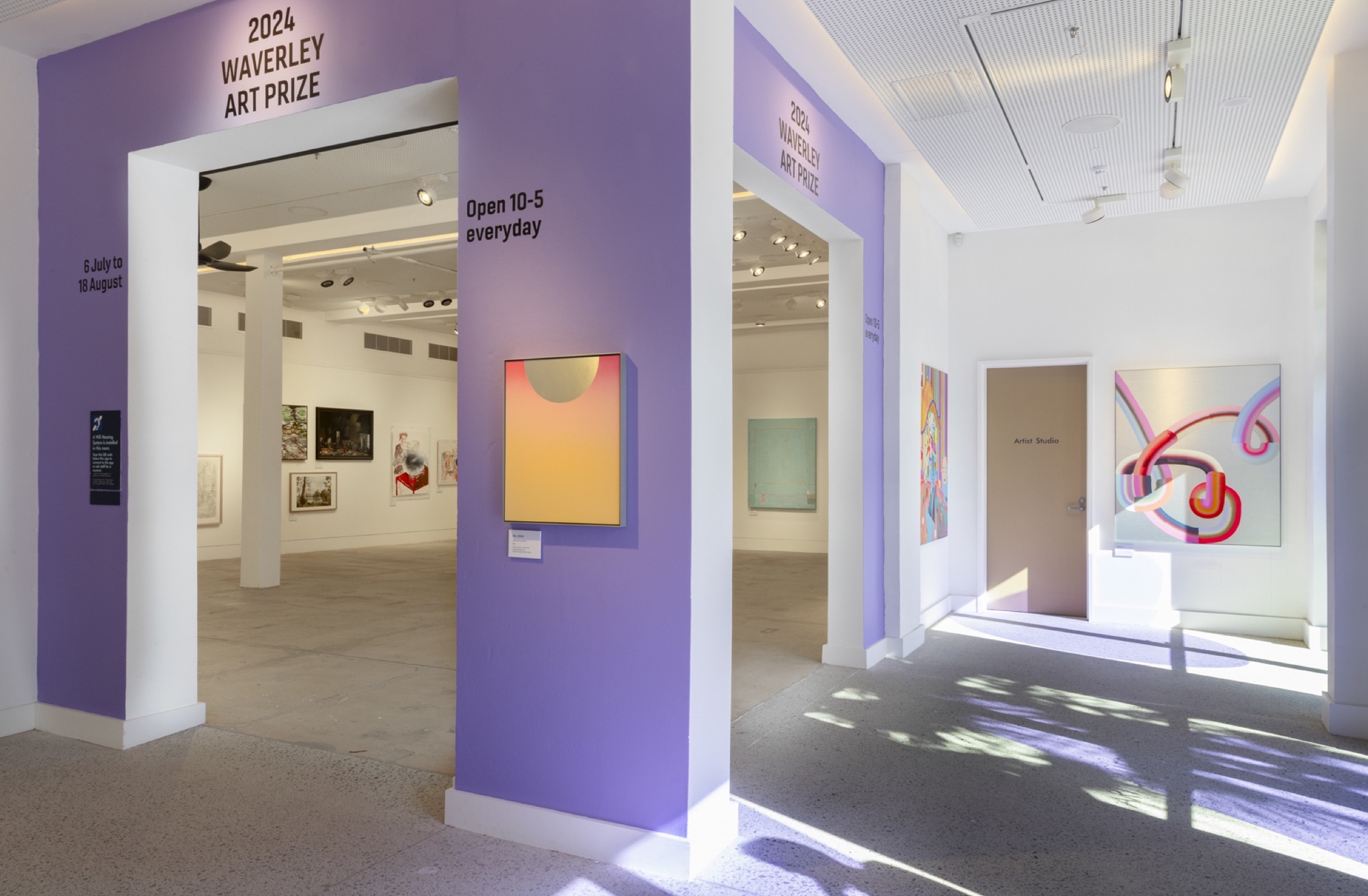Waverley Art Prize entrance with applied exhibition title, visitor information and purple gallery graphics in Sydney.